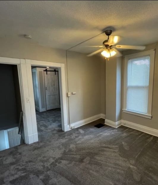 an empty room with a ceiling fan