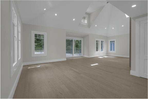 an empty living room with white walls and wood floors