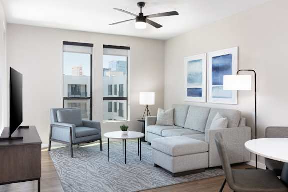 a living room with a couch and chairs and a tv at AVE Phoenix Sky, Phoenix, AZ