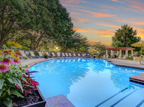 a swimming pool with a sunset in the background at Sunscape Apartments, Virginia, 24018