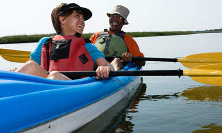two people in a kayak on a lake