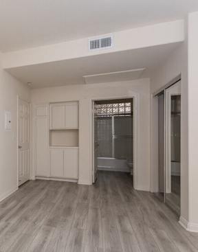 A room with a white wall and a grey floor.