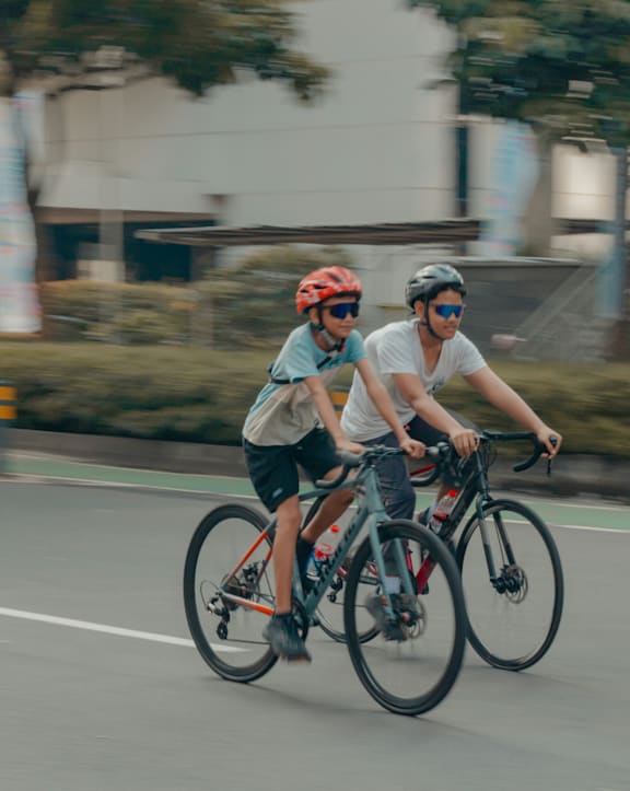 Two People Riding Bikes