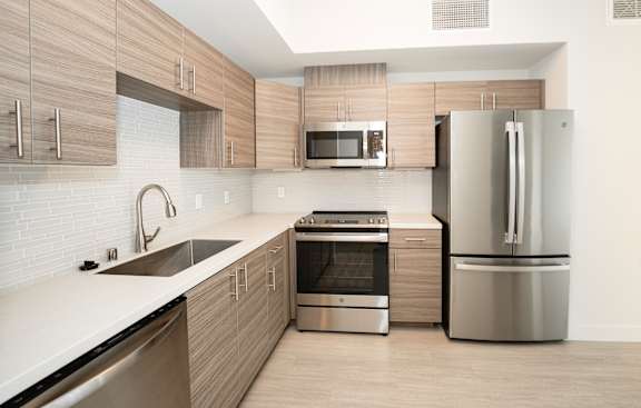 a modern kitchen with stainless steel appliances and wooden cabinets at Second & B Street, San Rafael, CA, 94901
