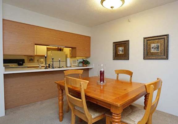 a dining room and kitchen with a table and chairs