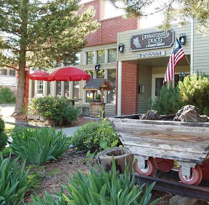 a boat sitting in a garden in front of a building