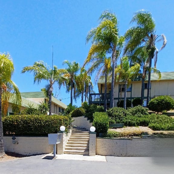a house with palm trees in front of it