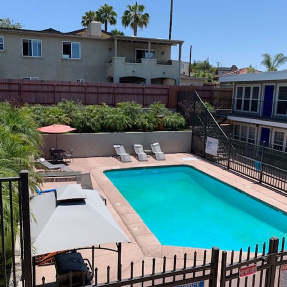 a pool in a backyard with a house in the background