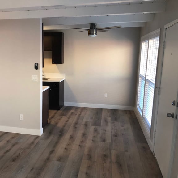 a bedroom with hardwood floors and a ceiling fan