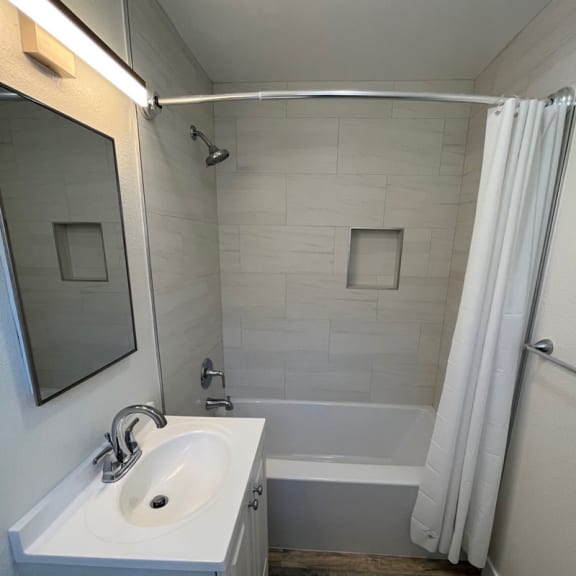 a small bathroom with a sink and a bathtub