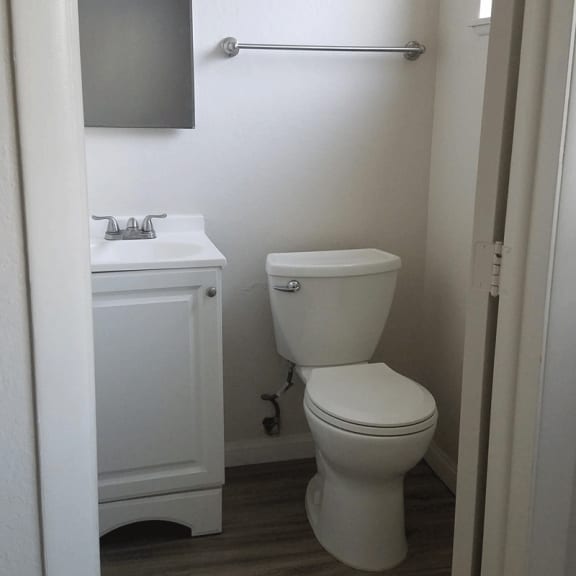 a small bathroom with a toilet sink and mirror