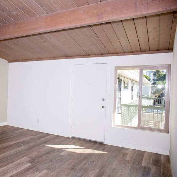 a room with white walls and a wooden ceiling