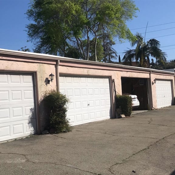 a house with two garage doors and a car in the driveway