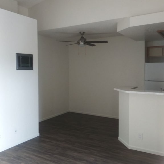 an empty room with a ceiling fan