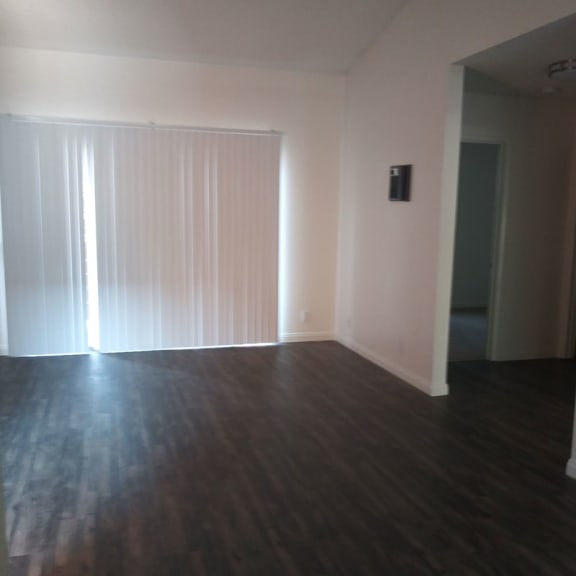 an empty living room with a large window