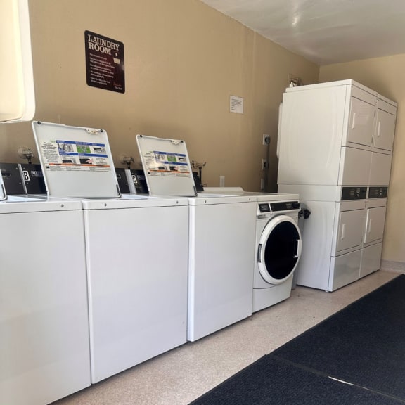 a laundry room with washers and dryers