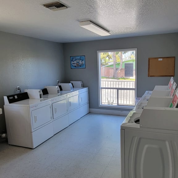a laundry room with washers and dryers