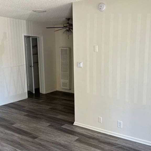 a bedroom with a ceiling fan and a door to a closet