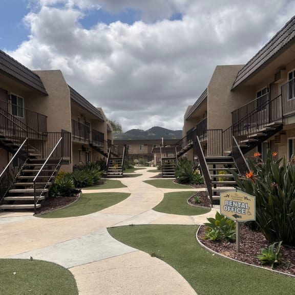 a view of a pathway in the middle of an apartment complex