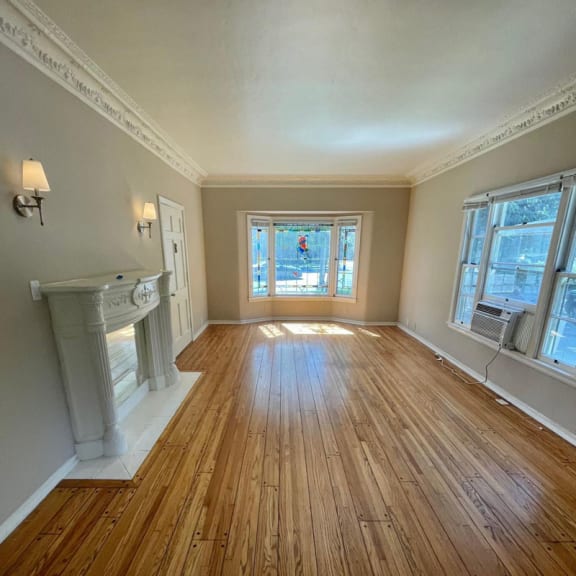 a living room with a fireplace and hardwood floors
