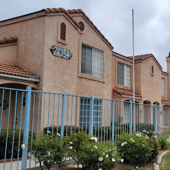 a building with a blue fence in front of it