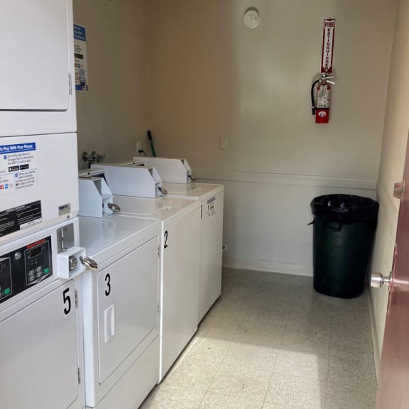 a laundry room with washers and dryers