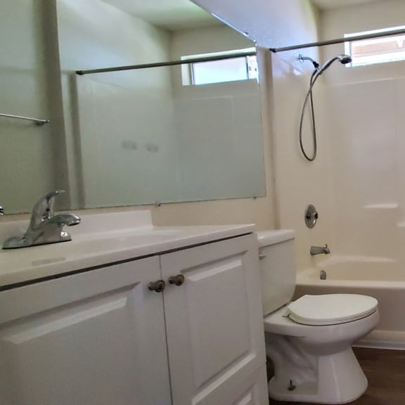 a bathroom with a sink toilet and shower