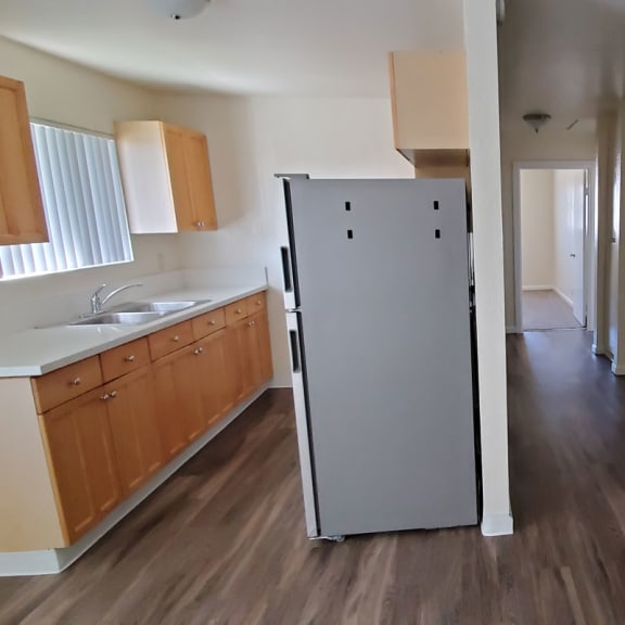 a kitchen with a refrigerator and a sink