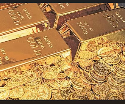 Gold bars and coins are piled on top of each other.
