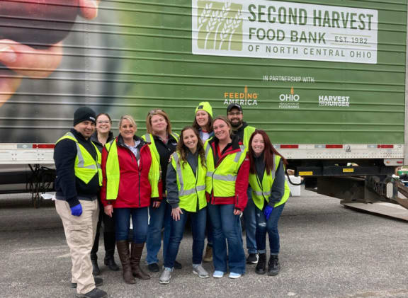 a group of people standing in front of a truck
