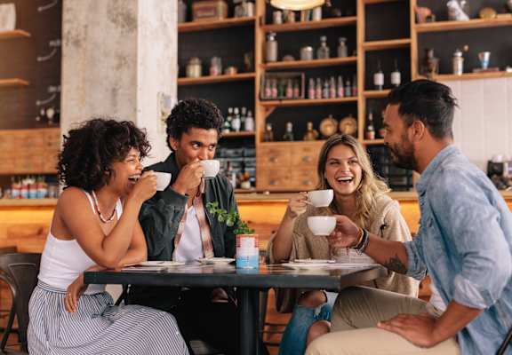 Four people are sitting at a table in a restaurant.