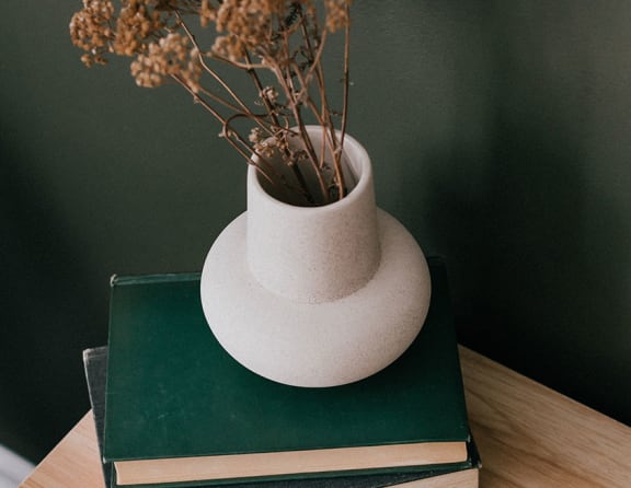 a vase on a book on a table