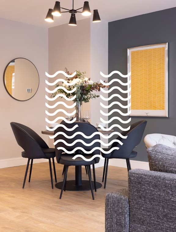 a dining room with a table and chairs and a wavy curtain on the wall