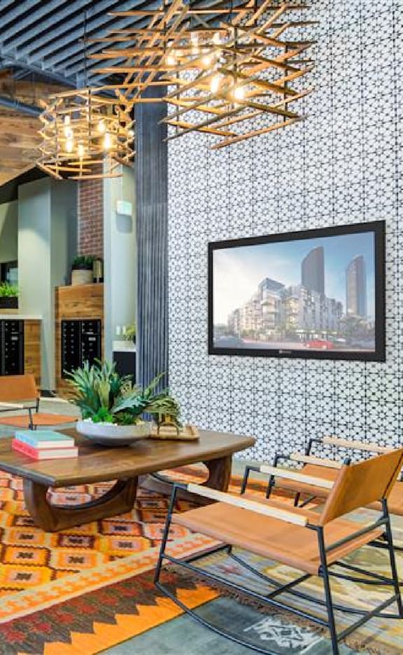 A room with a wooden table and chairs, a potted plant, and a framed picture of a city skyline on the wall.