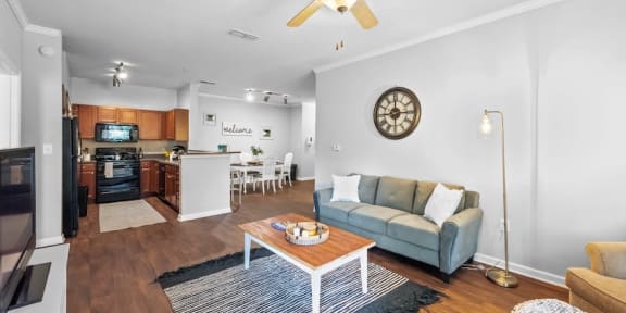 The open living room, kitchen, and dining space in the Centerville Manor Apartment model home