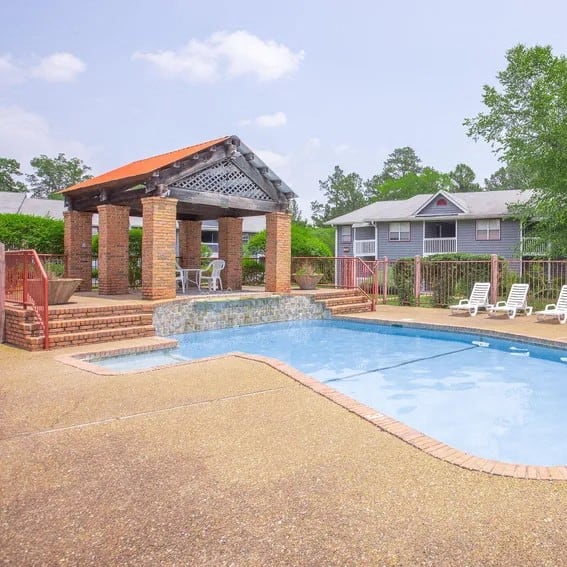 our apartments have a resort style pool with chairs and a gazebo