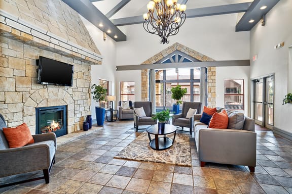 Grand Centennial Apartments clubhouse with lounge, fireplace and kitchen
