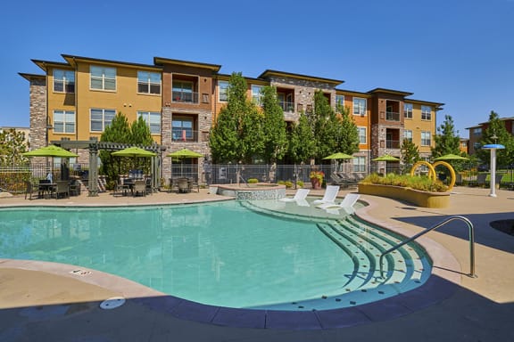 Acadia at Cornerstar Apartments resort-inspired pool with tanning shelf and heated spa