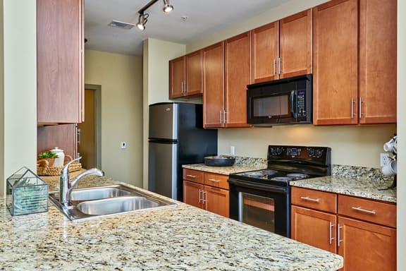 Acadia at Cornerstar Apartments custom 42-inch espresso-colored kitchen cabinetry