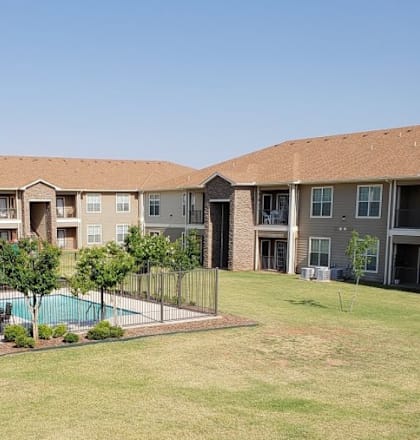 Apartment complex with a pool in the middle.