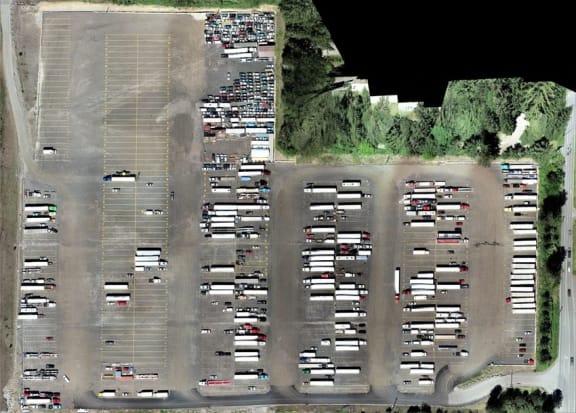 an aerial view of a parking lot with cars