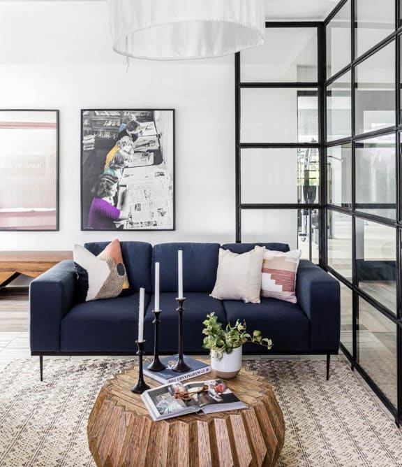 a modern living room with a blue couch and a coffee table