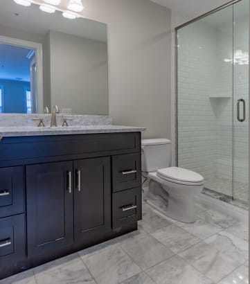 a bathroom with a toilet sink and shower