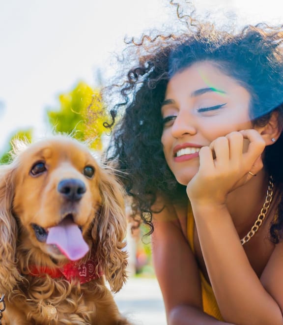 a woman laying on the ground with her dog