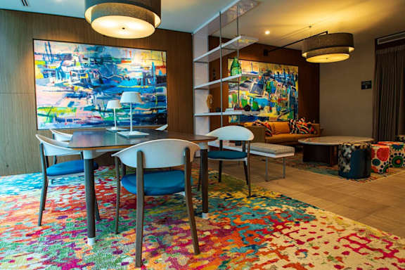 A dining room with a table and chairs.