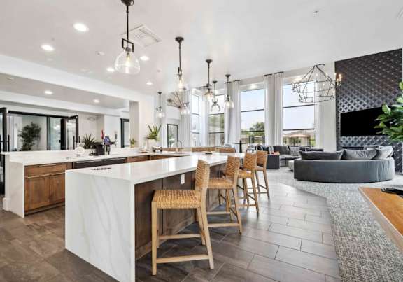 A modern kitchen with a bar area and a dining table set up.