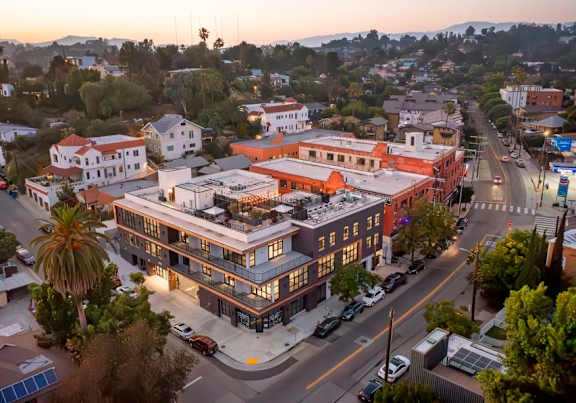 A street view of a town with a large building in the center.
