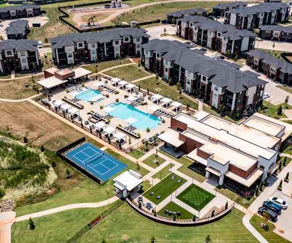 The aerial view at 35 Degrees with a view of the rooftop, sports courts, and two pools. 