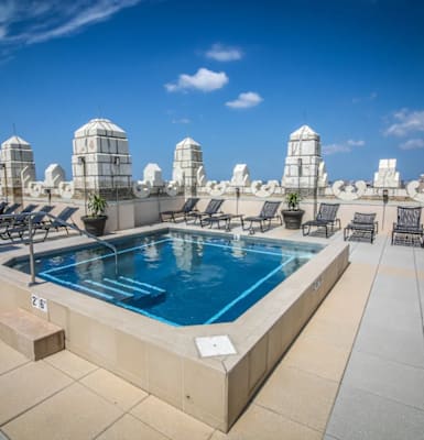 a swimming pool on the roof of a skyscraper