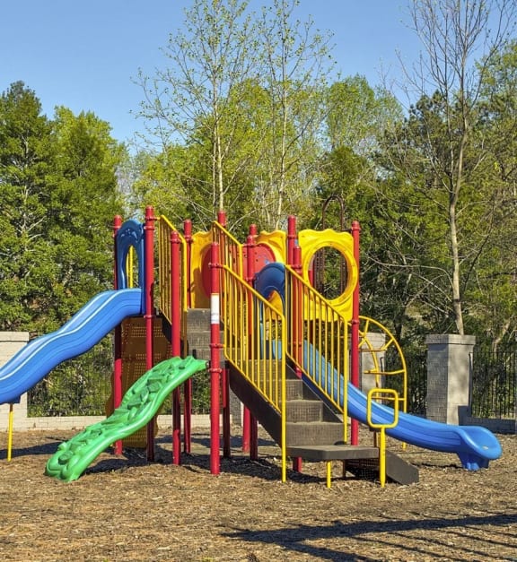 a colorful playground with slides in a park